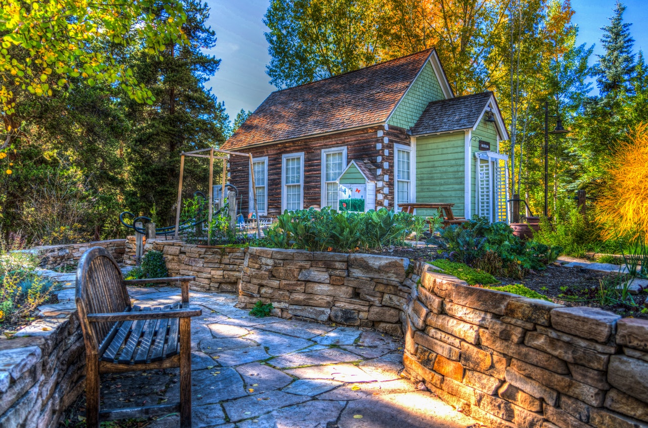 home in forest with garden and bench